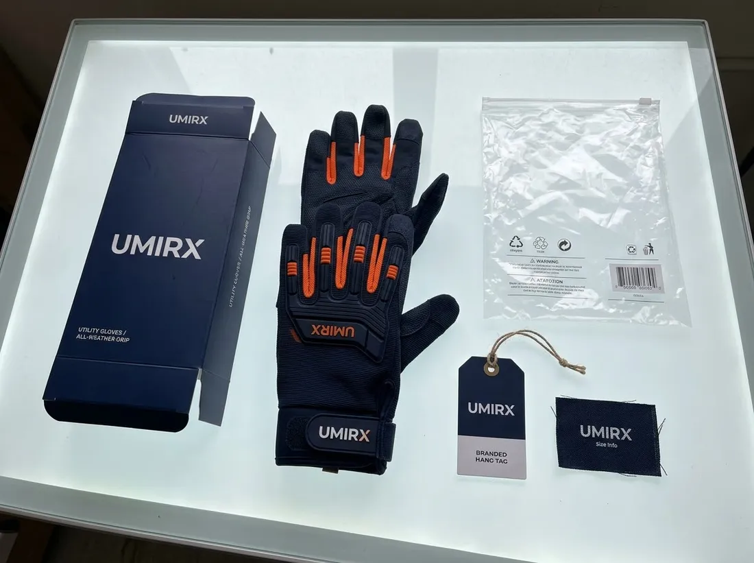 Glove packaging laid out: printed box, hang tag, woven label, polybag and a glove