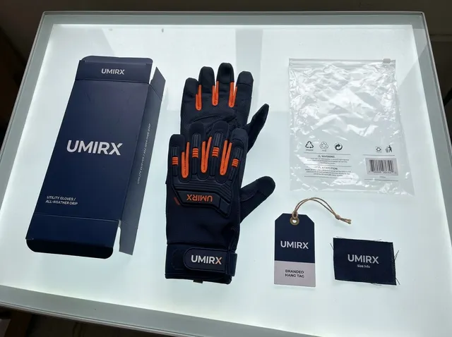 Glove packaging laid out: printed box, hang tag, woven label, polybag and a glove