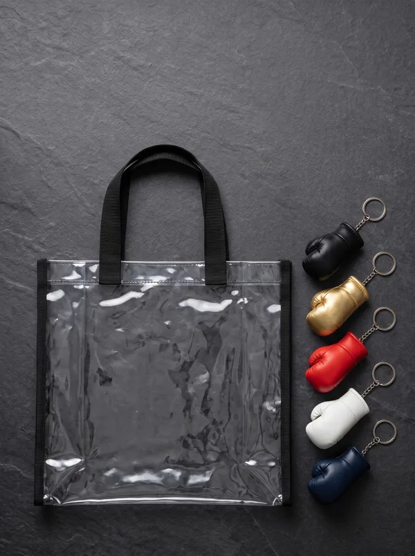 Mini boxing-glove keychains and a clear stadium bag